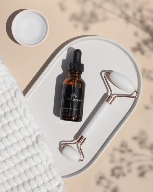 Glycolic Acid Serum with facial roller on tray